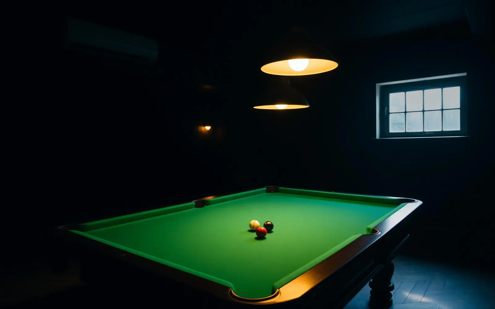 Lit pool table in a dark hall at Century Makers